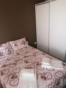 a bedroom with a bed with two towels on it at Complex Karia I in Kavarna +75 photos