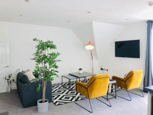 a living room with a couch and chairs and a table at Shield Penthouse Loft - 2 Bedroom Luxe Large Apartment in Sheffield