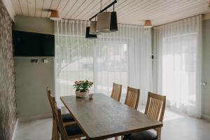 a dining room with a table and chairs at Garden Apartment in Cēsis