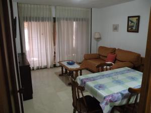 a living room with a couch and a table at Los Pinos - Fincas Arena in Benidorm