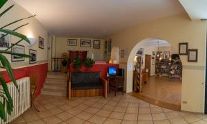 a living room with an archway and a couch and a table at Due Torri in San Severino Marche