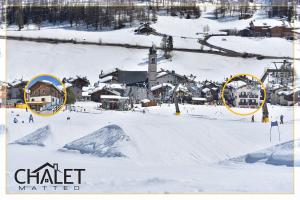 a group of buildings in the snow with a town at Chalet Goloseria in Livigno