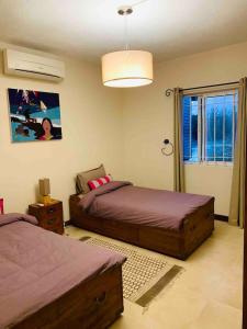 Säng eller sängar i ett rum på appartement Grand Baie île Maurice