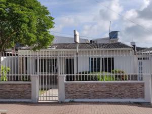 a white fence in front of a house at Posada Doña Rosa in San Andrés