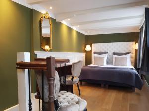 Postel nebo postele na pokoji v ubytování Boutique Hotel Huys van Leyden