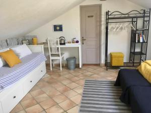 a bedroom with a bed and a desk with a chair at La Vignarelle in Callas