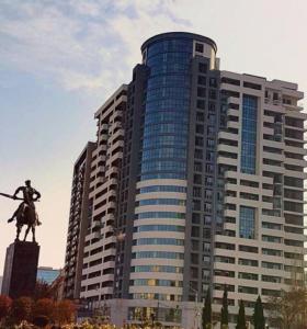 a large building with a statue in front of it at Mia B&B Tbilisi in Tbilisi City