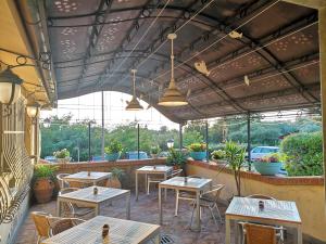 a patio with tables and chairs in a restaurant at Locanda Miranda in Tellaro