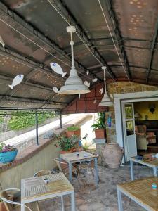an outdoor patio with tables and chairs and lights at Locanda Miranda in Tellaro