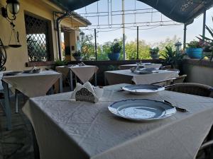 a table with plates on it in a restaurant at Locanda Miranda in Tellaro
