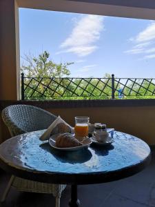 a table with a plate of food and two glasses of orange juice at Locanda Miranda in Tellaro