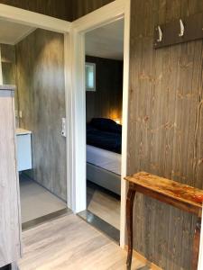 a bedroom with a bed and a wooden wall at Morud in Meistervik