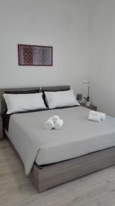 a bedroom with a large bed with towels on it at Ca' dei Mille in Iseo