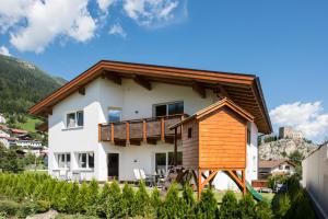 a house with a wooden roof at Ladis Living in Ladis