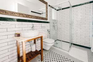 a bathroom with a sink and a toilet and a mirror at Boutique hotel Corso in Řevnice +105 photos