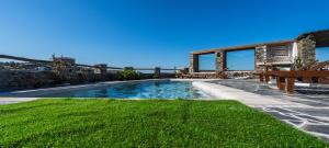 a swimming pool in a yard with a bench at Plakoto House in Exámbela
