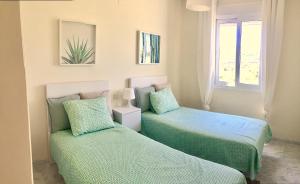 A bed or beds in a room at Valle Romano golf resort Capitolio Estepona Még 31 kép