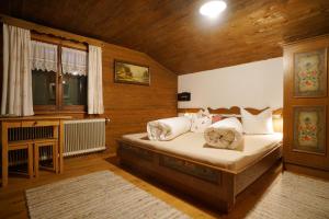 a bedroom with a bed in a wooden room at Apartment Jaegerhaus in Andelsbuch