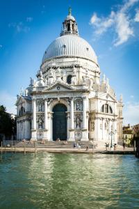 a domed building with water in front of it at The judas trees in Mestre