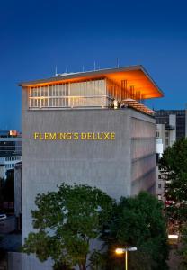 a large building with a clock on the top of it at Flemings Selection Hotel Frankfurt-City in Frankfurt