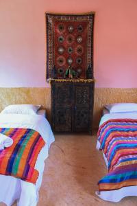 Ein Bett oder Betten in einem Zimmer der Unterkunft L'oasis Du Bonheur