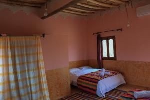 Ein Bett oder Betten in einem Zimmer der Unterkunft L'oasis Du Bonheur