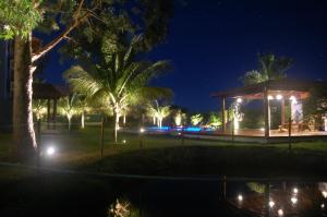 a gazebo with lights in a park at night at Mangaba Village in Barra Grande