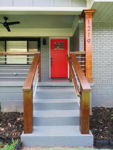 a red door on a house with a porch at Modern Bungalow Near Downtown in Atlanta