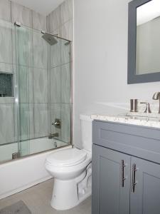 a bathroom with a toilet and a shower and a sink at Modern Bungalow Near Downtown in Atlanta