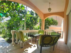 a patio with chairs and a table with bottles on it at Apartments & Studios Tomanović in Budva