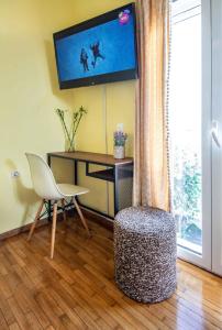 a living room with a desk and a tv on the wall at Central 6th Floor Studio Near Metro & View&200mbps in Athens