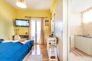 a bedroom with a bed and a bathroom with a sink at Central 6th Floor Studio Near Metro & View in Athens