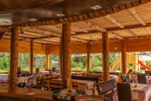 a restaurant with tables and people sitting at tables at Camp Sutjeska in Tjentište