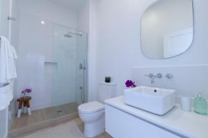 a white bathroom with a sink and a toilet at Mullins Grove in Saint Peter