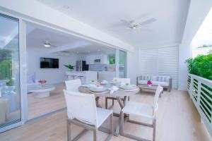a dining room with a table and white chairs at Mullins Grove in Saint Peter