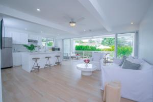 a living room with a white couch and a kitchen at Mullins Grove in Saint Peter
