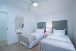a bedroom with two beds and a mirror at Mullins Grove in Saint Peter