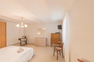 a bedroom with a bed and a table and chairs at SOTTO LA PORTA BOREA in Citta' Sant'Angelo