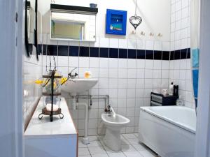 a bathroom with a sink and a toilet and a bath tub at Eklanda Bed & Breakfast in Gothenburg