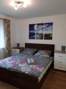 a bedroom with a bed with flowers on it at Lawendowy Zakątek - Agroturystyka in Lewin Kłodzki