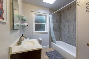 a bathroom with a sink and a tub and a window at @ Marbella Lane 5BR House in Downtown Redwood City in Redwood City