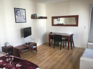 a room with a desk and a table with a mirror at Studio Palermo La Rural y Embajada USA in Buenos Aires