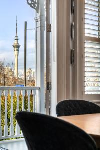 a balcony with two chairs and a view of the eiffel tower at Franklin38 in Auckland