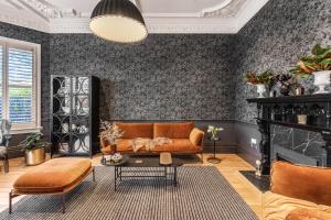 a living room with a couch and a table at Franklin38 in Auckland