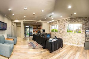 a lobby with a table with a computer on it at Suburban Studios Charlotte-Ballantyne in Charlotte