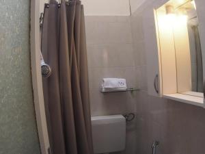 a bathroom with a toilet and a shower curtain at Casa Vacanze Bungalow I Girasoli in Ventimiglia