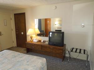 a hotel room with a television and a bed at Arlington Inn in Port Clinton