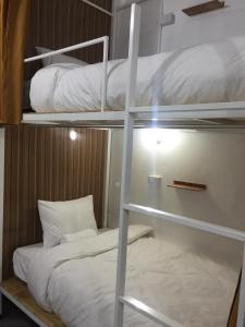 a bunk bed in a room with a bunk bed gmaxwell gmaxwell gmaxwell gmaxwell at Naga Hostel & Café in Thakhek