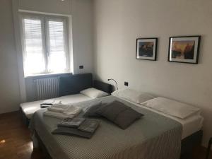 a bedroom with a bed and a window at Feel@Home Apartment+Rooms in Milan