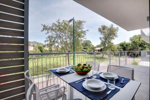 a table with a bowl of fruit on a balcony at Venice Golf residence in Venice-Lido